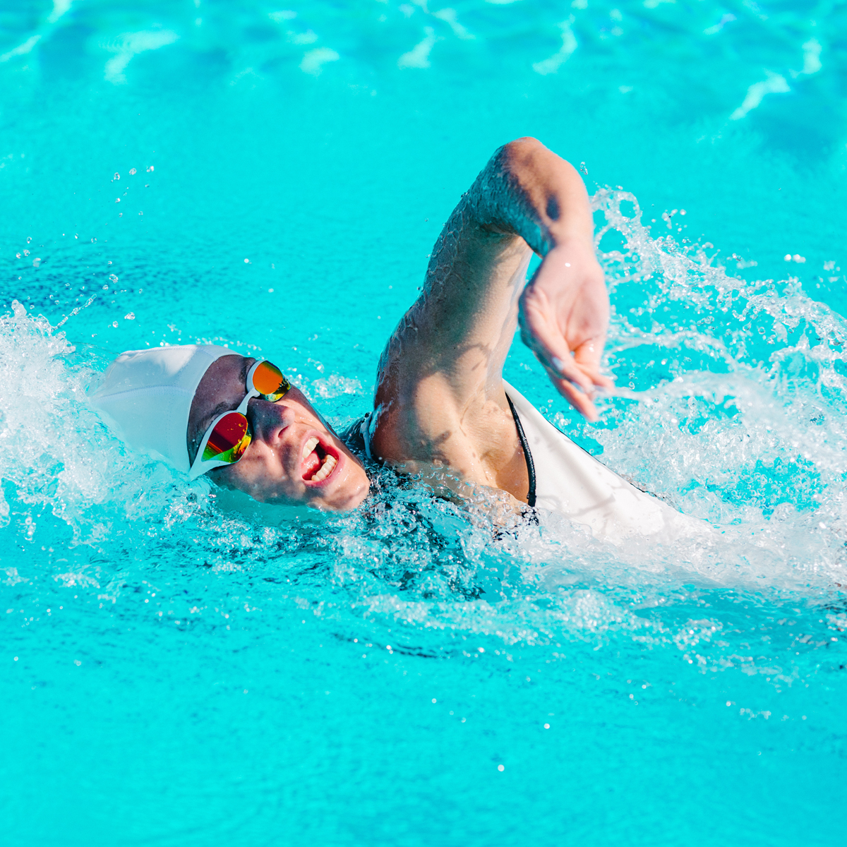Swimmer powering through open water with a strong freestyle stroke